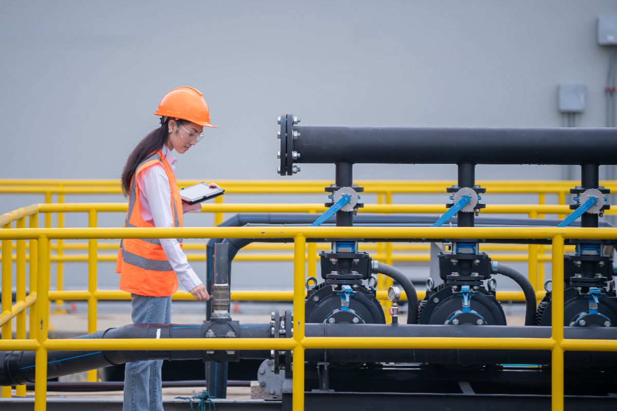 Female worker inspecting the industrial chillers