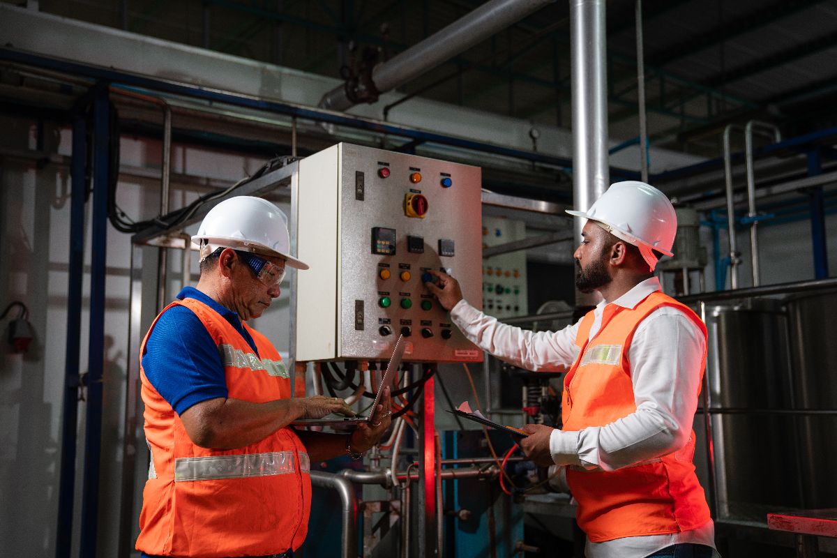 Engineers checking on the settings of an industrial chiller