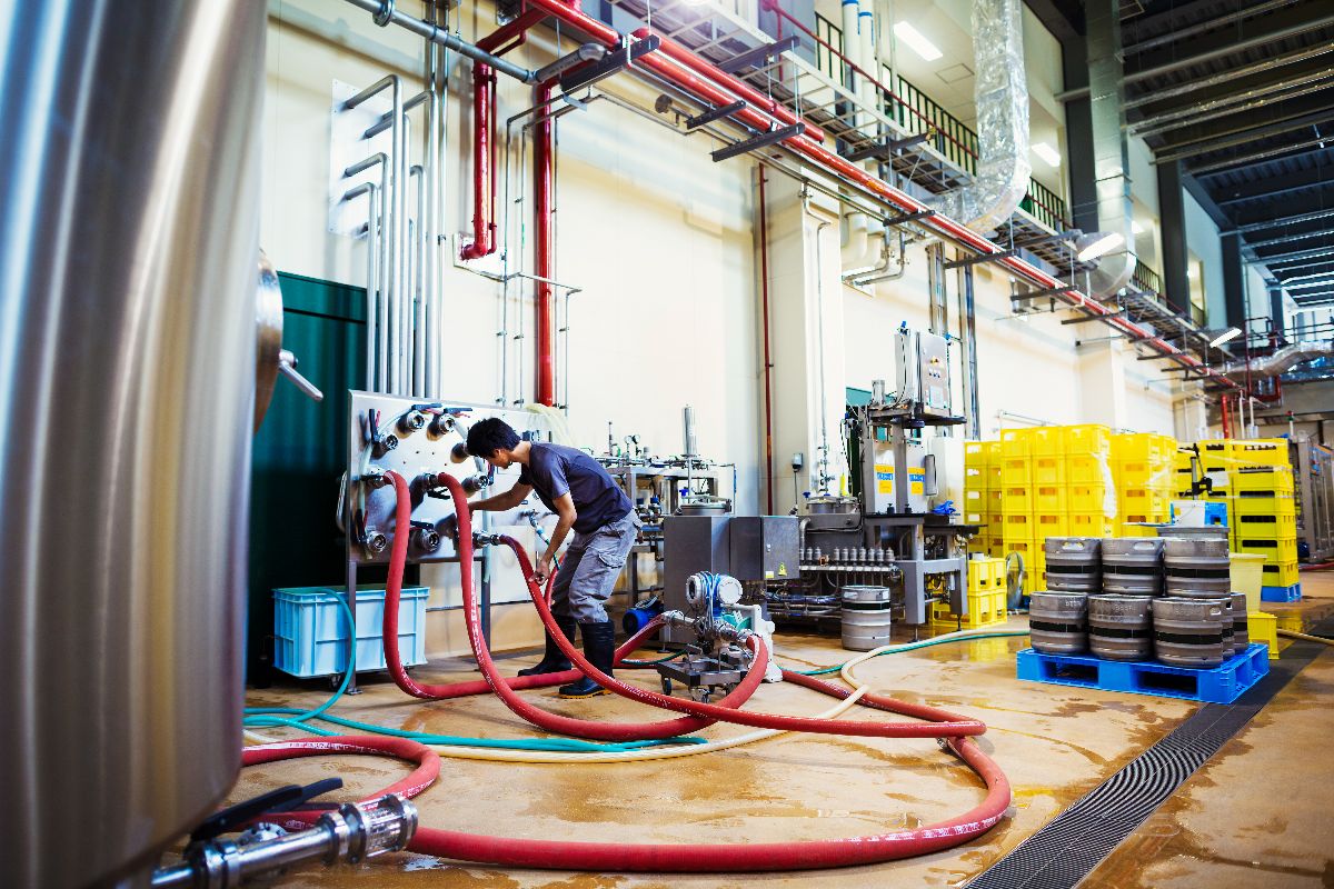 A worker doing cleaning on an indsutrial chiller