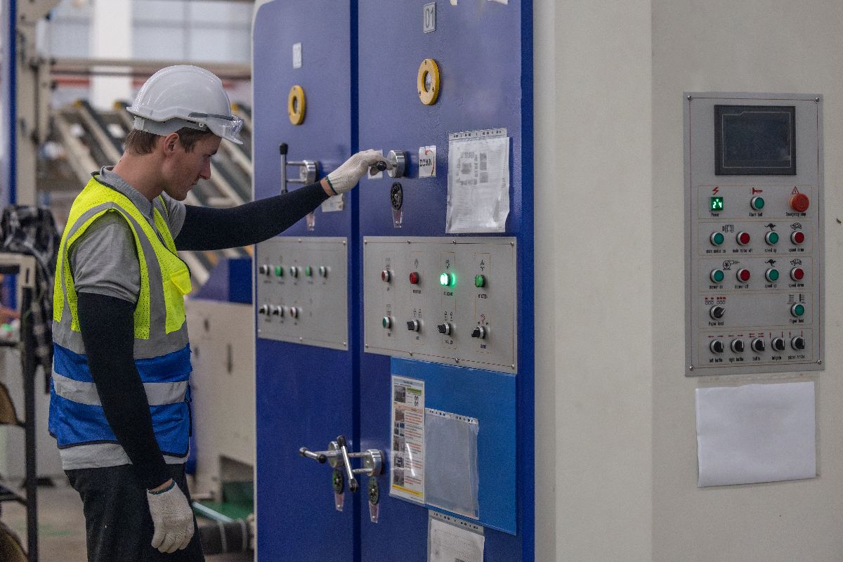 An industrial worker doing maintenance with the equipment at a facility