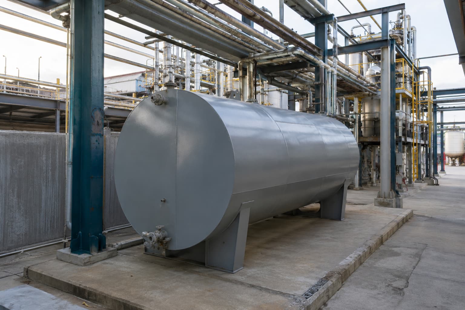 Steel water storage tank fitted around industrial space and piping constraints