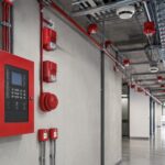 Fire alarm control panel with detectors and notification devices in an industrial facility